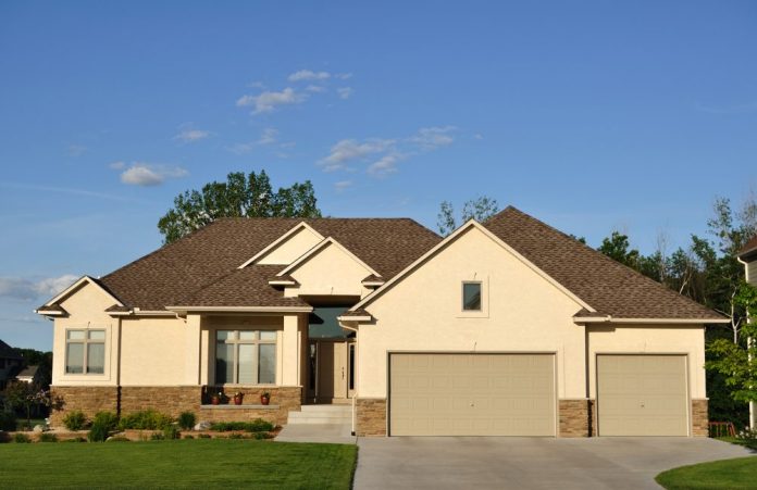 front of a house in tan color