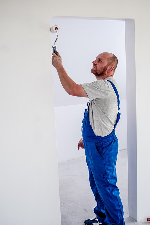 man painting the wall