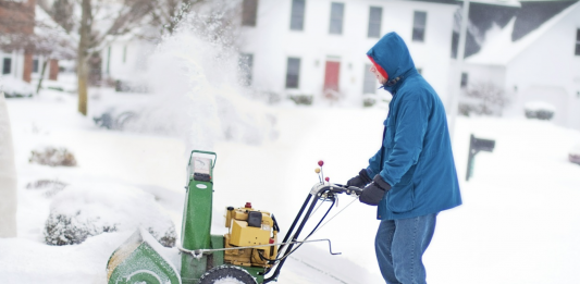 man using the snow blower