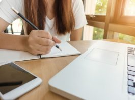 table with laptop and and person study