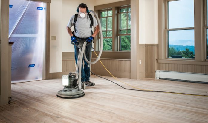man working on the best floor buffer for home use