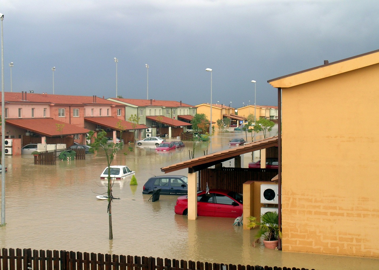 homes and cars caught in a flooded area 