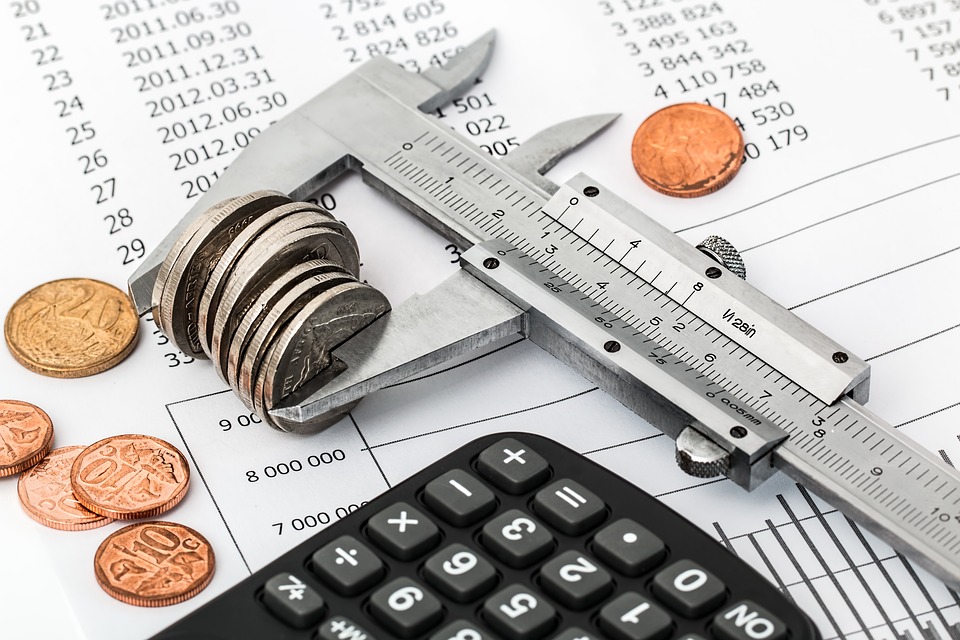 Calculator and coins on the table